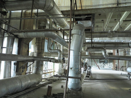 Giant glitter tubes, equipment, cables and piping inside of a modern industrial power plantの写真素材