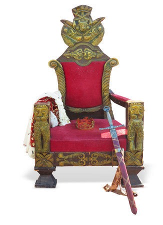 Old red golden king throne with sword and crown isolated over white background.の写真素材