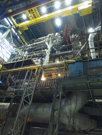 Industrial big water pumps with electric motors, pipes, tubes, equipment and steam turbine at modern power plantの写真素材