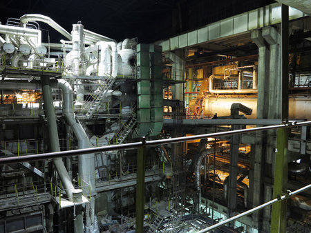 Pipes, steel tubes, steam turbine and equipment at industrial power plant, night sceneの写真素材