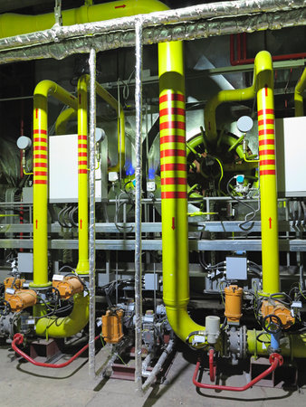 Gas yellow tubes at an industrial thermal electric power plant, night sceneの写真素材
