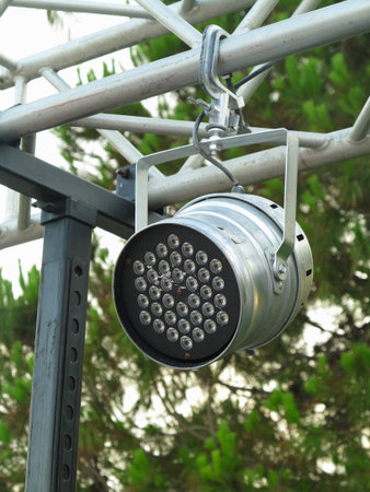 Old spotlights projectors on metallic stage structural elements