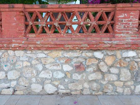 The old fence wall of vintage brick decoratedの写真素材