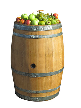 Old wooden vintage barrel with fruits on top isolated over white backgroundの写真素材