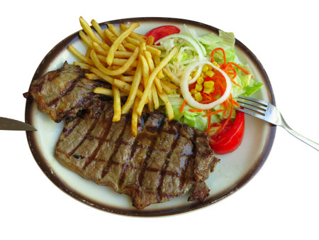 Grilled meat, french fries and salad on white plate isolated on whiteの写真素材