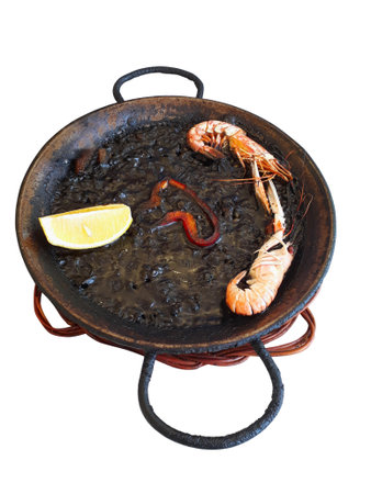 Spanish black squid ink paella with lobsters and scallops isolated on white. Classical Spanish cuisineの写真素材