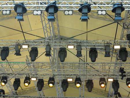 Spotlight devices in a row on  rigging steel trusses, installation of professional stage concert equipment.の写真素材