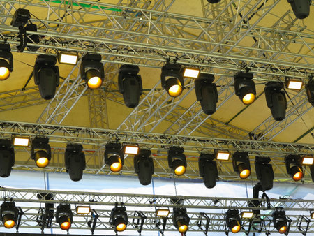 Spotlight devices in a row on  rigging steel trusses, installation of professional stage concert equipment.のeditorial素材