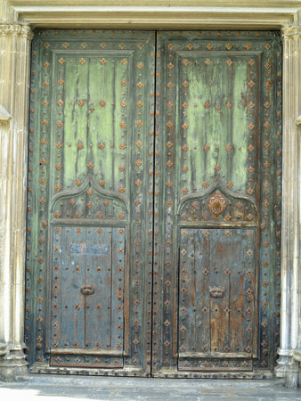 An ancient weathered stylish old wooden brown and green doorの写真素材