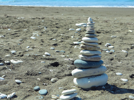 a pyramid of stones on the seashore.の写真素材