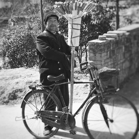 Elderly selling sugar coated fruits with his bicycleのeditorial素材