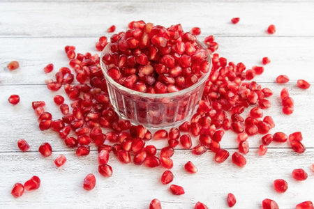 Seeds of the pomegranate overflowing from the glass bowlの写真素材