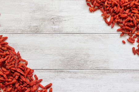 Dried goji berries on white wooden background. Top view.の写真素材