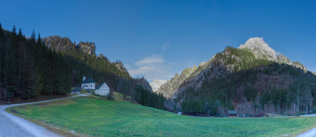 Panoramic view of beautiful small church and cemetery for mountaineer and climbers in Johnsbach village, in The Gesause National Park, Styria region, Austriaの写真素材