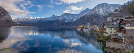 Panoramic view of Hallstatt, a charming village on the Hallstattersee lake and a famous tourist attraction, with beautiful mountains surrounding it, in Salzkammergut region, Austria, in winter.の写真素材
