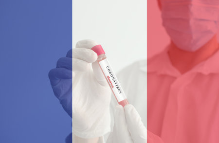 Coronavirus conceptual photo with doctor wearing a medical face mask and gloves, holding a blood test result for the COVID-19 pandemic and national flag of France, blurred backgroundの写真素材