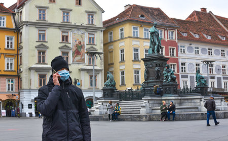 Graz/Austria - March 09, 2020: Man on city street wearing a face mask for protection against viruses during coronavirus COVID-19 and flu outbreakのeditorial素材