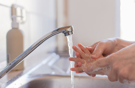 Close up hands of a small children washing hands with soap and water. Clean and hygiene concept.の写真素材
