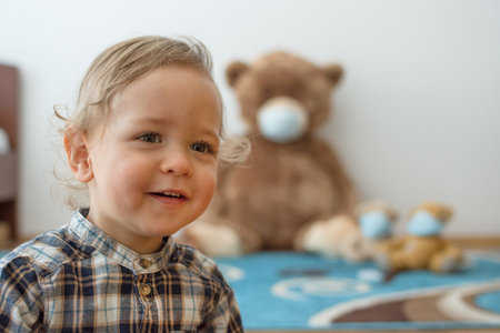 Child playing with his sick teddy bears wearing medical mask against viruses. Role playing, child playing doctor with plush toy. Children and flu, coronavirus illness concept. Selective focusの写真素材