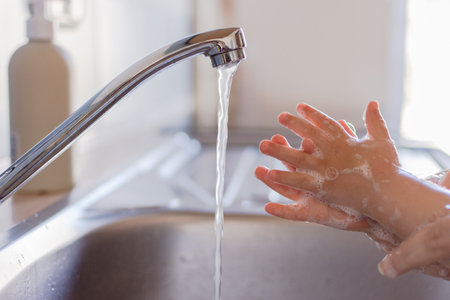 Close up hands of a small children washing hands with soap and water. Clean and hygiene concept.の写真素材
