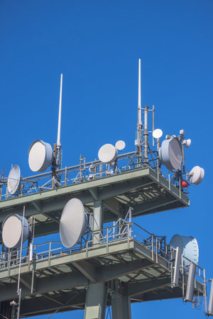 Detail of a telecommunication tower with directional mobile phone and internet antennas. Wireless communication equipment transmitter. 5G Technology.の写真素材