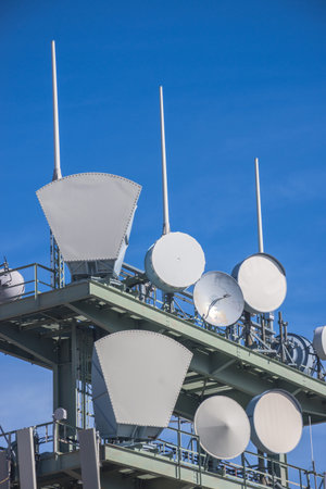 Detail of a telecommunication tower with directional mobile phone and internet antennas. Wireless communication equipment transmitter. 5G Technology.の写真素材