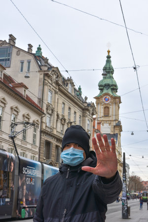 Graz/Austria - March 09, 2020: Man on city street wearing a face mask for protection against viruses during coronavirus COVID-19 and flu outbreakのeditorial素材