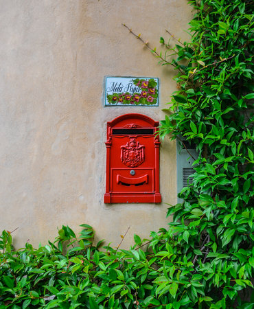 Bergamo/Italy - July 14, 2016: Red mailbox surrounded by greenery in Bergamo, Upper City, famous tourist destination in Lombardy, Italy.のeditorial素材