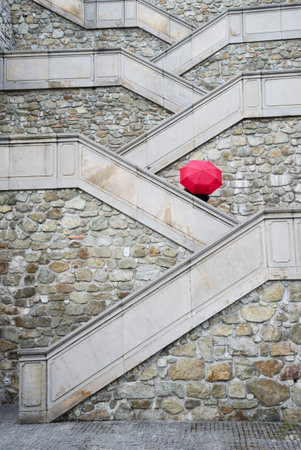 Red umbrella on the beautiful stairs to Bratislava castle, Slovakia.のeditorial素材
