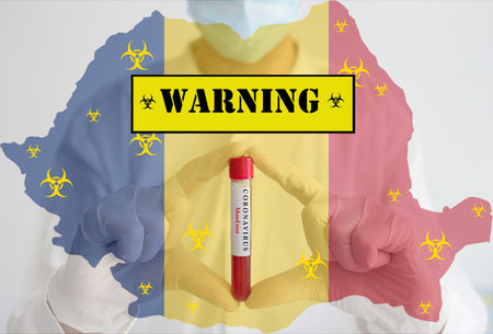 Doctor wearing a medical face mask and gloves, holding a blood test for the Coronavirus COVID-19 pandemic rapidly spreading and national flag of Romania. Coronavirus warning conceptual photo.の写真素材