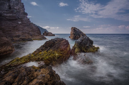 Rocks and waves on the sea near Cinque Terre - Manarola, picturesque fishermen villages in the province of La Spezia, Liguria, Italyの写真素材
