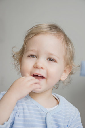Happy sweet little baby boy portrait on white backgroundの写真素材