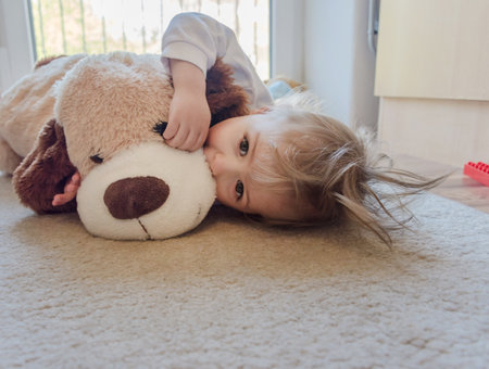 Cute boy playing with his plush toysの写真素材