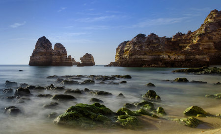 Color, cliffs, seashell hunting, caves, arches and wonderful views at Dona Ana Beach (Praia de Dona Ana), in Lagos, Western Algarve coast, Portugal.の写真素材