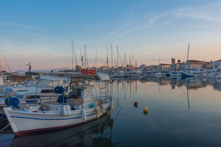 Port of Aegina town with yachts and fishermen boats docked in Aegina island, Saronic gulf, Greece, at sunrise.の写真素材