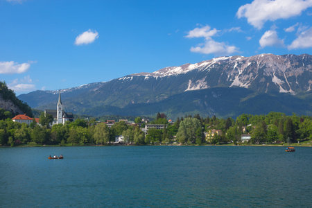 Sunny spring morning at Lake Bled and Julian Alps in the background, famous tourist attraction in Sloveniaの写真素材