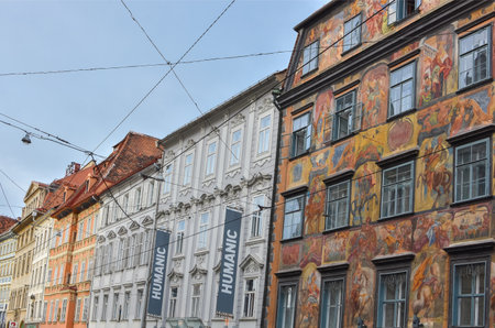 Graz/Austria - February 02, 2020: Building facades on Herrengasse street with Herzoghof building (painted house)in the city center of Graz, Styria region, Austria.のeditorial素材