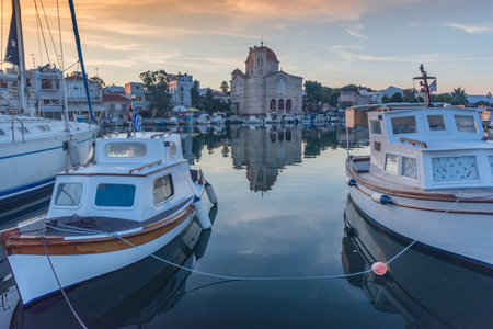 Port of Aegina town with yachts and fishermen boats docked in Aegina island, Saronic gulf, Greece, at sunrise.の写真素材