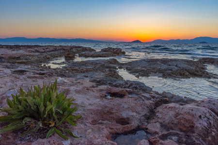 Beautiful sunset at Mediterranean Sea with wild and rocky beachesの写真素材