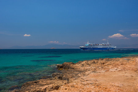 Cruise ship sailing on the clear and blue waters of Mediterranean sea in the Saronic gulf, Greece.の写真素材