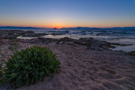 Wild coast of the Aegina island, Saronic gulf, Greece, at sunset.の写真素材