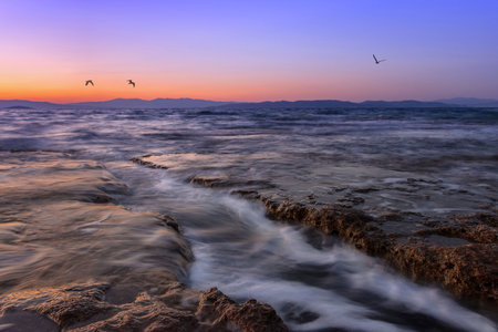 Beautiful sunset at Mediterranean Sea with wild and rocky beachesの写真素材