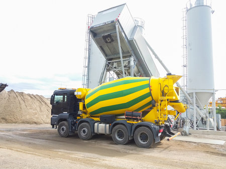 Concrete mixer truck in front of a concrete batching plant, cement factoryの写真素材