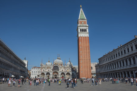 Venice, Italy - April 20, 2019: View of Saint Mark square (San Marco), with Doges Palace (Palazzo Ducale), bell tower (campanile) and Basilica di San Marco, in a beautiful sunny day.のeditorial素材