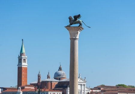 The St. Mark's Square (Piazza San Marco) with column with winged lion and San Giorgio di Maggiore church in the background, in Venice, Italyの写真素材