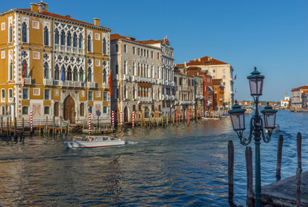 Beautiful Venetian view with old historical houses and boats on Grand Canal, in Venice, Italyのeditorial素材