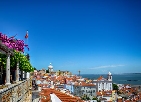 Beautiful panoramic view from Santa Luzia viewpoint (miradouro) to Alfama old town, with Santa Estevao Church, National Pantheon (Santa Engracia Church) and Tagus river, in Lisbon, Portugal.の写真素材
