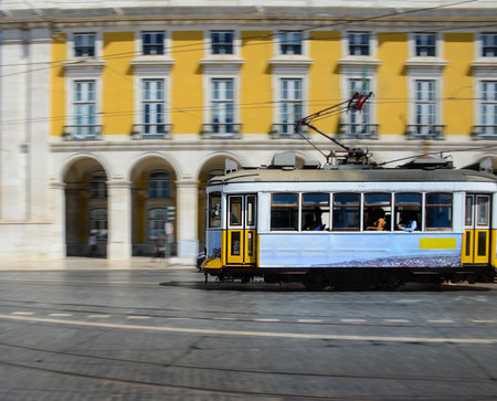 Vintage yellow tramway at the Commerce Square, in Lisbon, Portugal. Photography made using the panning technique.の写真素材