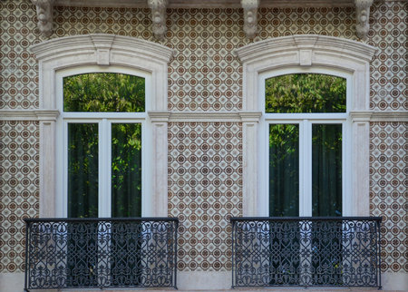 Typical portuguese window with ornamental tiles called "azulejos", made with colored ceramic tiles, in Lisbon, Portugalの写真素材