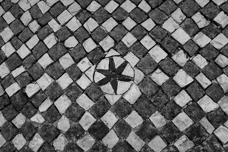 Typical portuguese cobblestone hand-made mosaic pavement, in Lisbon, Portugal.の写真素材
